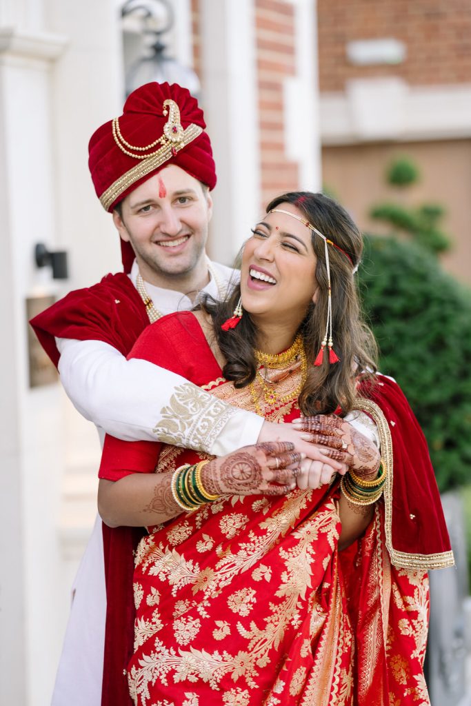 Hindu Wedding Couple laughing in front of Fairmont Hotel Windsor